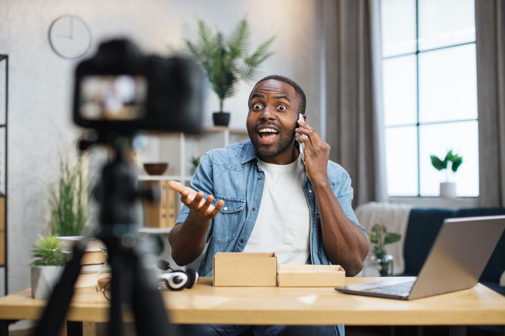 Happy man testing new smartphone while recording video